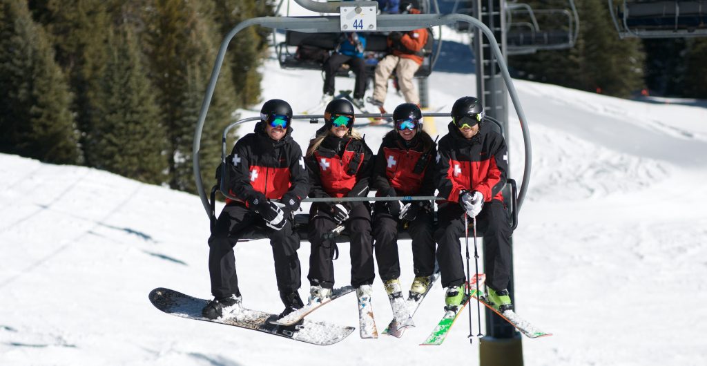 patrollers on ski lift chair