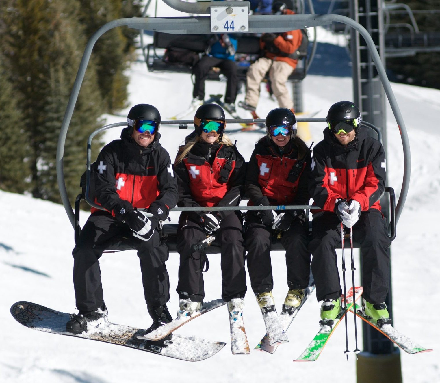 patrollers on ski lift chair