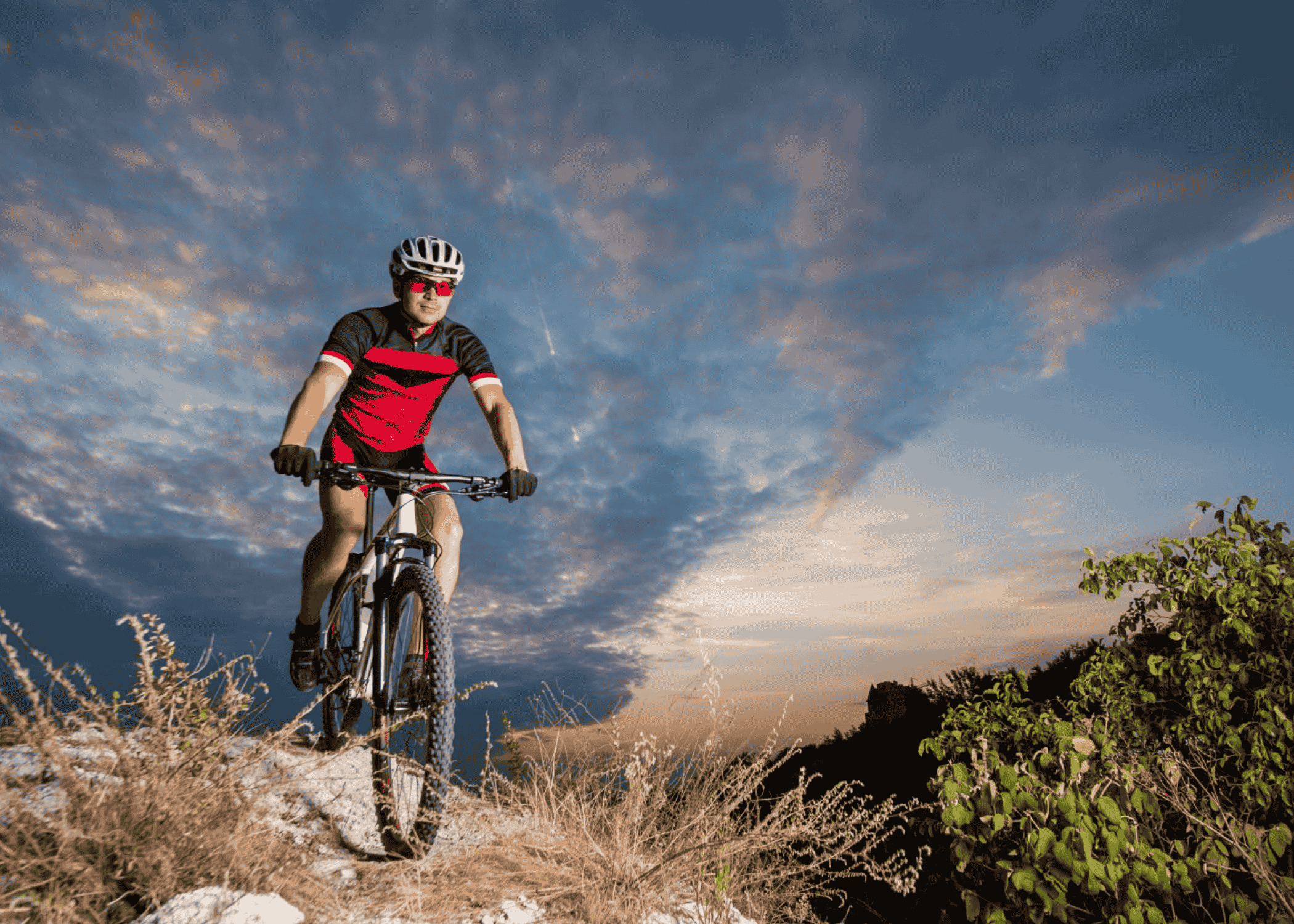 man riding bike on trail