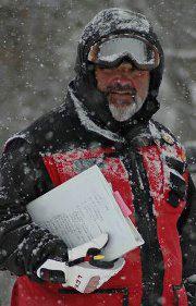 photo of Dan Somalski in patrol uniform with clipboard in hand, snow around